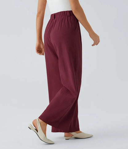 Pleated, flowing palazzo pants with a linen feel, side pockets, and wide legs.