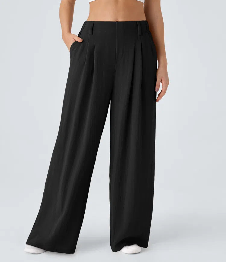 Pleated, flowing palazzo pants with a linen feel, side pockets, and wide legs.